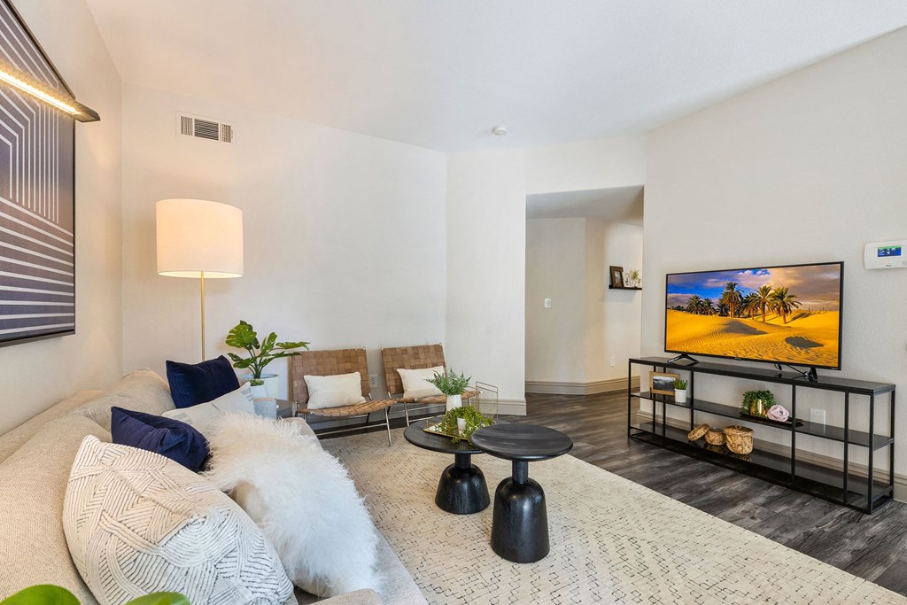 a living room with a couch and a tv at Mirasol Apartments, Nevada, 89119