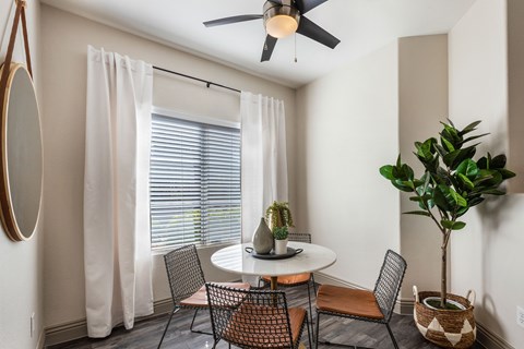 a dining room with a table and chairs and a ceiling fan at Mirasol Apartments, Nevada