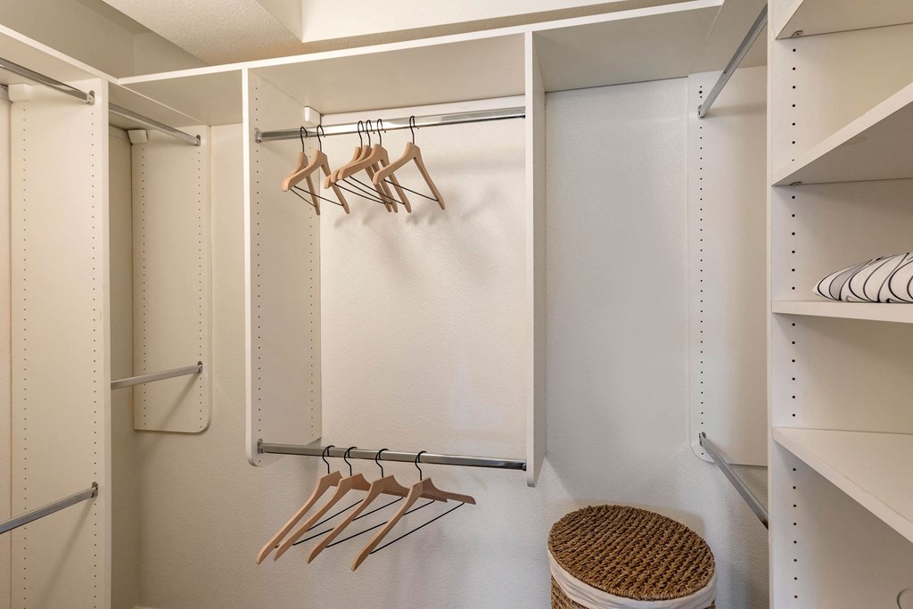 a walk in closet with hooks and a white wall at The Rays at Vegas Towers Apartments, Las Vegas, NV 89119