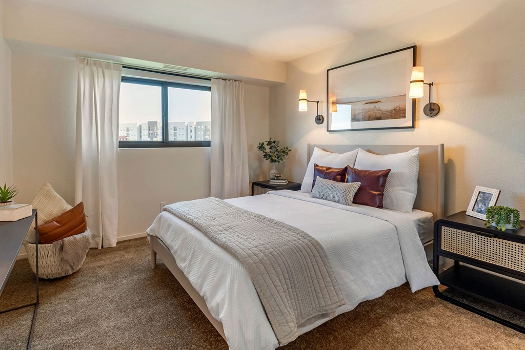 a bedroom with a large bed and a window at The Rays at Vegas Towers Apartments, Las Vegas, Nevada