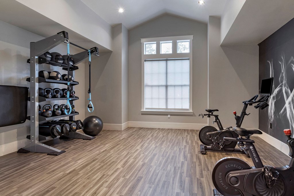 a home gym with exercise equipment and a bike at Reserve by the Lake, Houston, Texas