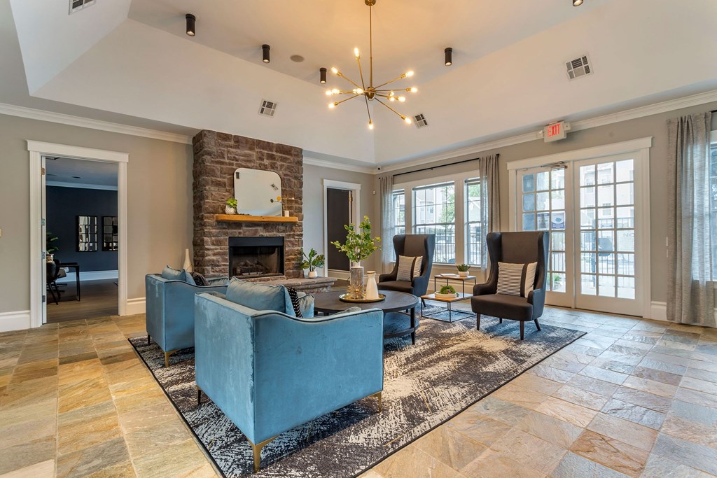 a living room with couches and chairs and a fireplace at Reserve by the Lake, Houston, TX, 77084