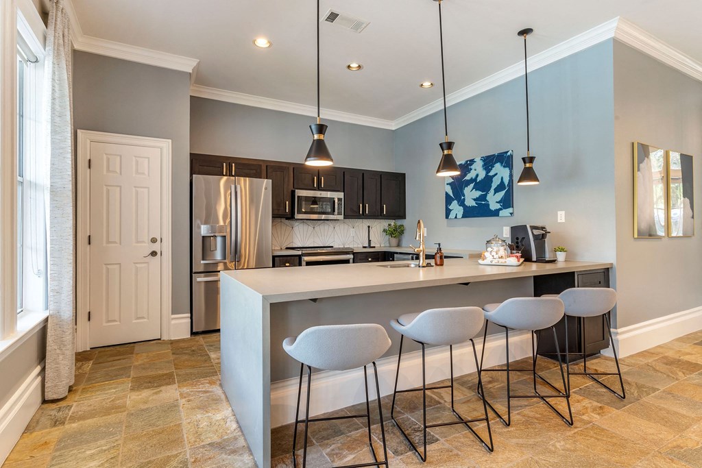 a kitchen with a bar and stools at Reserve by the Lake, Houston