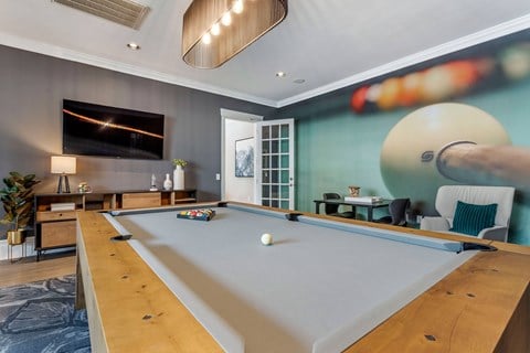 a game room with a pool table and a tv at Reserve by the Lake, Houston, TX, 77084