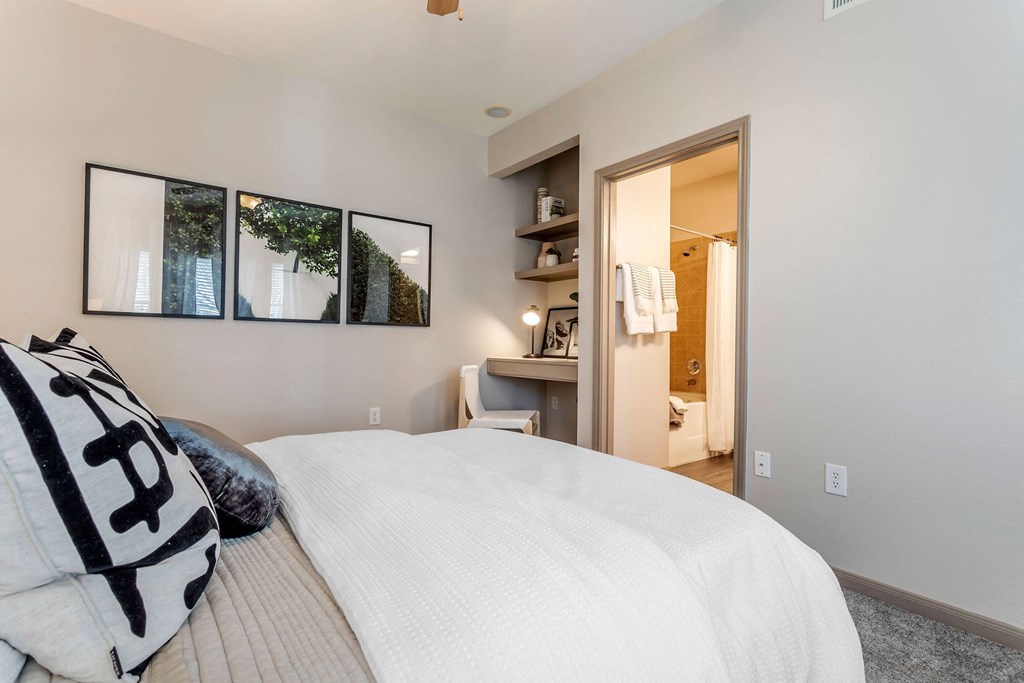 a master bedroom with a large bed and a bathroom at Reserve by the Lake, Houston, Texas