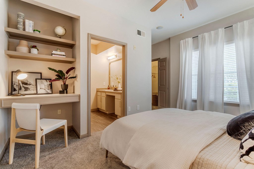 a bedroom with a bed and a desk with a mirror at Reserve by the Lake, Houston, Texas