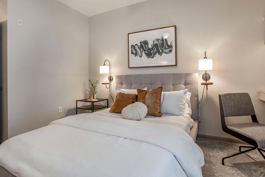 a bedroom with a large white bed and pillows a bedroom with a large white bed and pillows at Reserve by the Lake, Houston, Texas