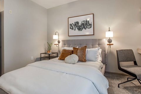 a bedroom with a large white bed and pillows at Reserve by the Lake, Houston, Texas