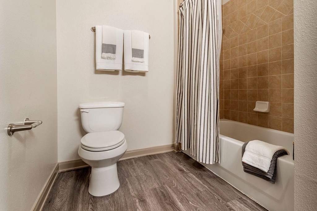 an image of a bathroom with a toilet and a bath tub at Reserve by the Lake, Houston, TX, 77084