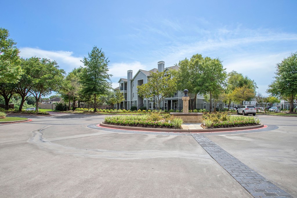 Entryway Roundabout with Apartment Building in the background at Reserve by the Lake, Houston