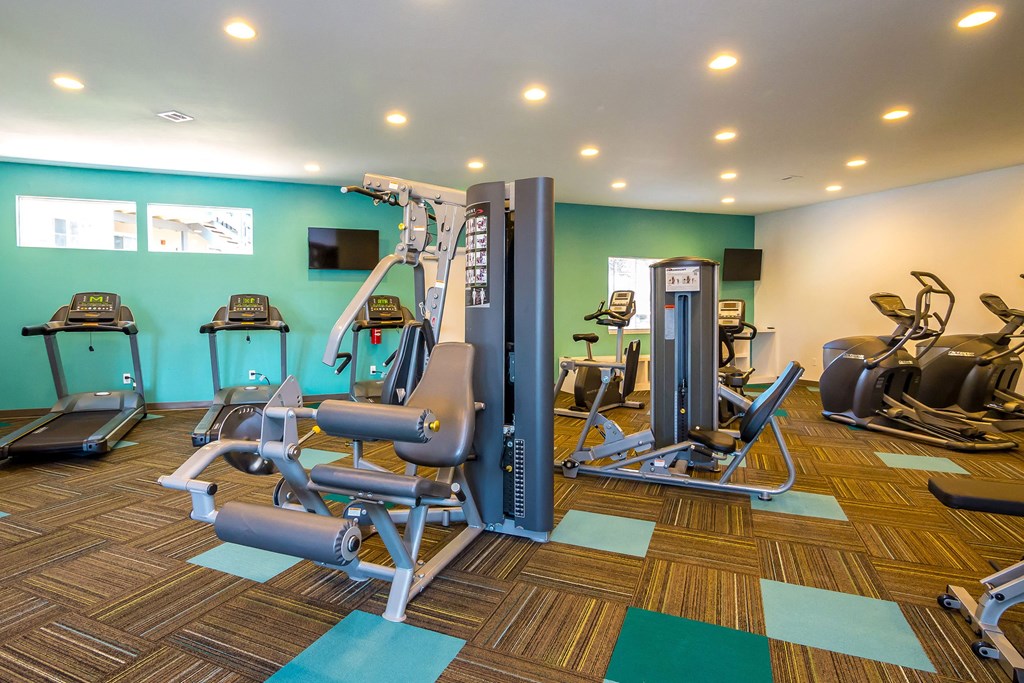 a gym with cardio equipment and weights in a wellness center at Skyview Apartments, Westminster Colorado