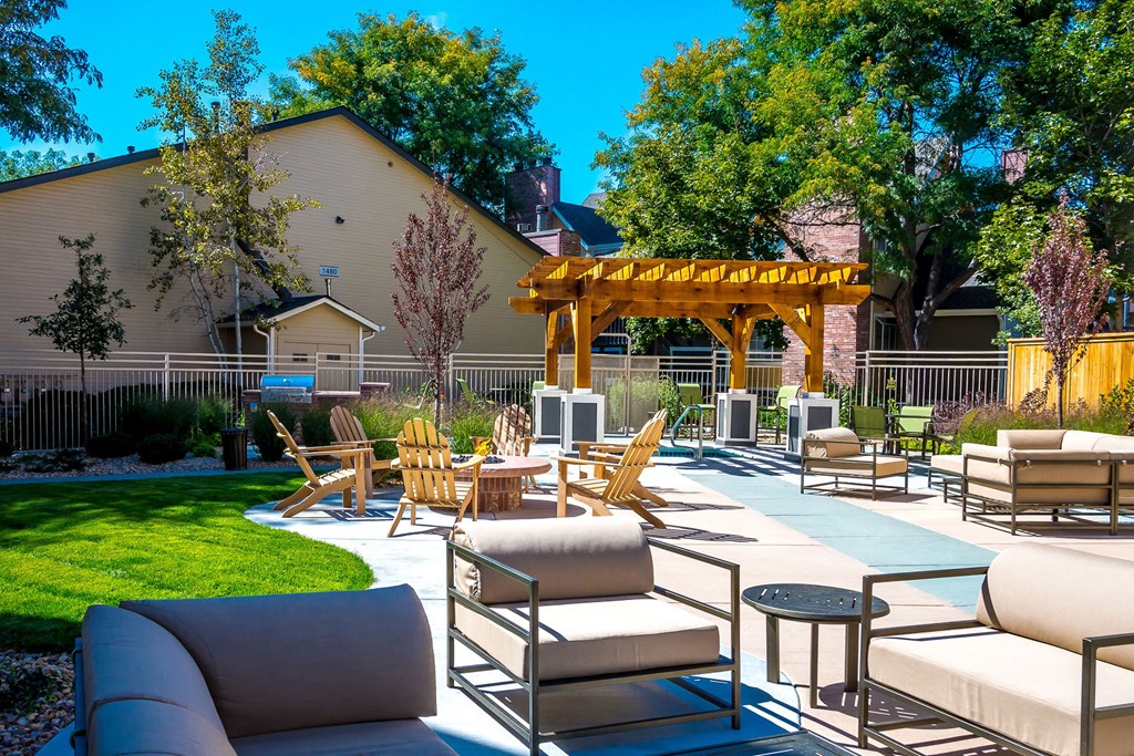 a patio with chairs and tables and a gazebo at Skyview Apartments, Westminster Colorado