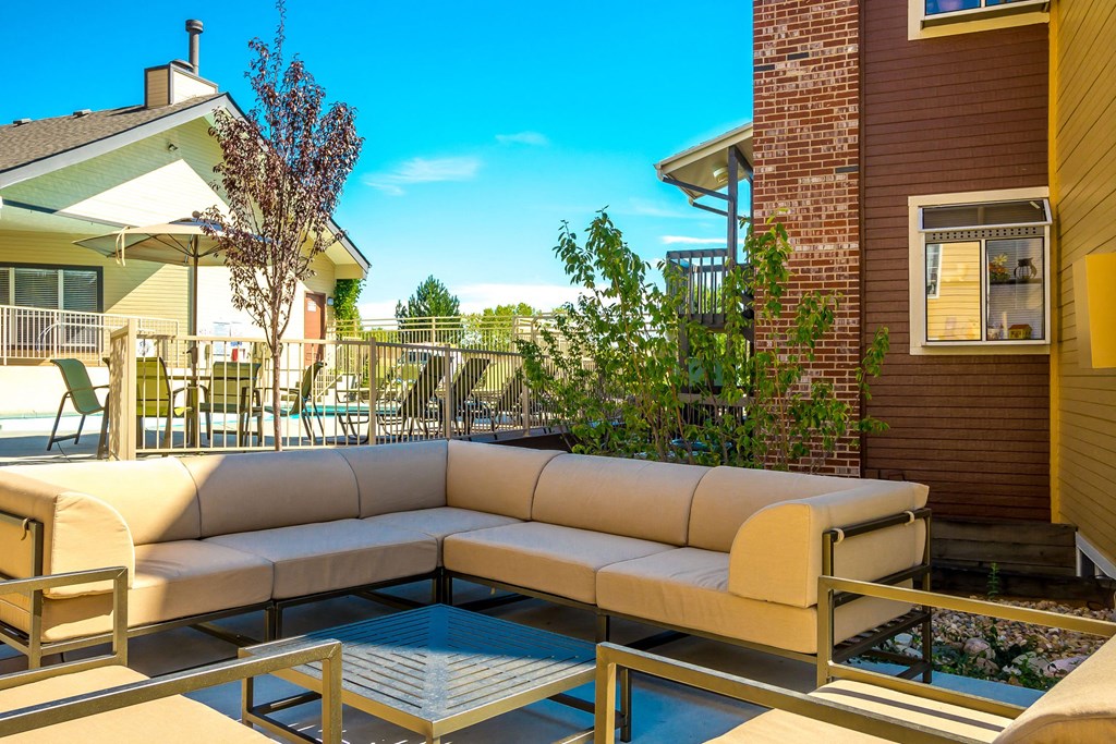 the patio of a house with a couch and tables at Skyview Apartments, Westminster