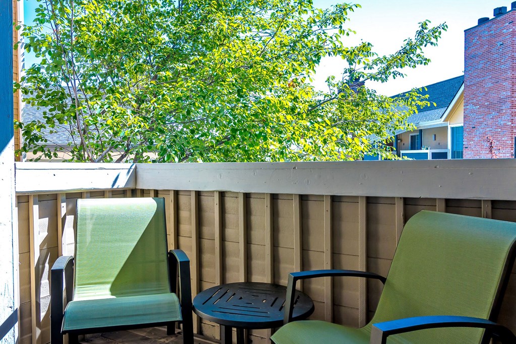 a patio with two chairs and a table on a balcony at Skyview Apartments, Colorado, 80234