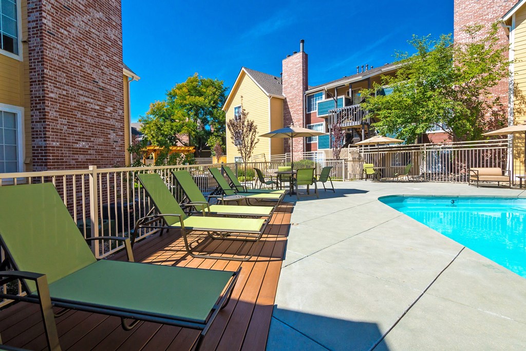 our apartments have a large pool and a deck with chairs at Skyview Apartments, Westminster, CO