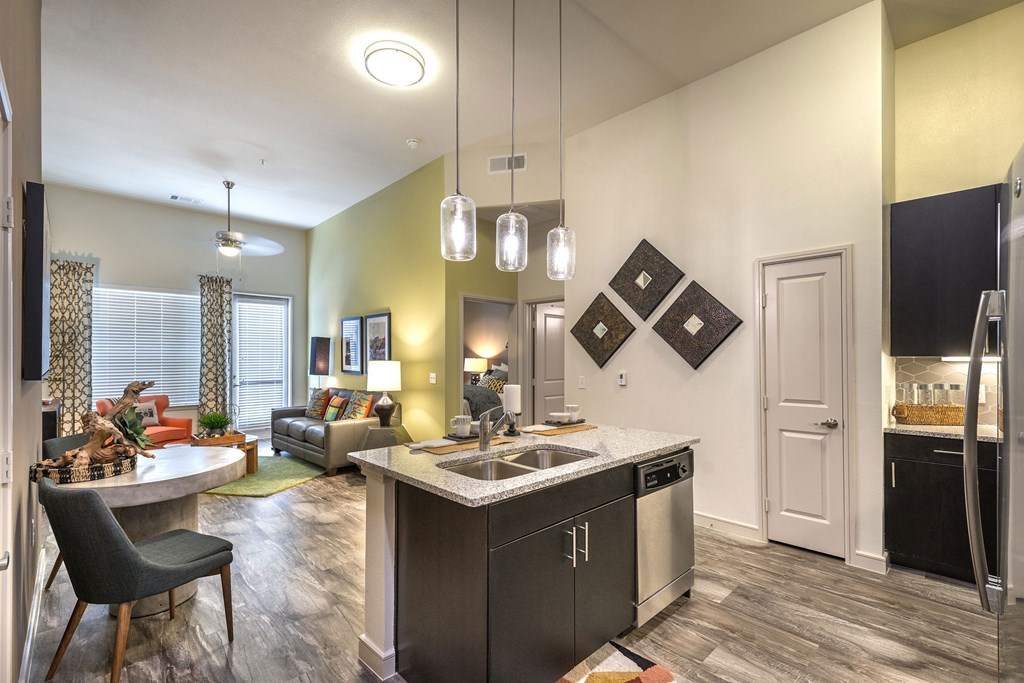 a kitchen and living room with a sink and a table at South Side Flats, Texas