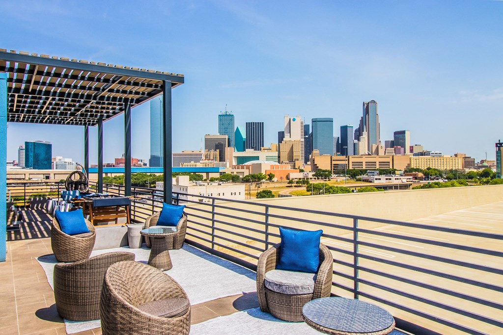 a rooftop deck with chairs and a view of the city at South Side Flats, Texas, 75215