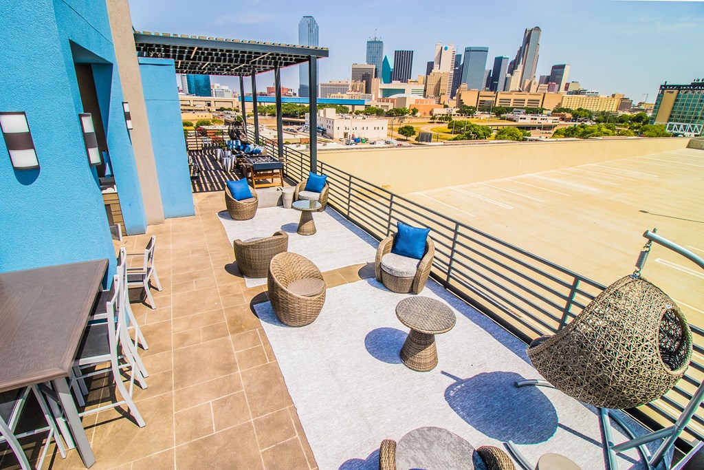 a rooftop patio with tables and chairs and a view of the city at South Side Flats, Dallas, TX