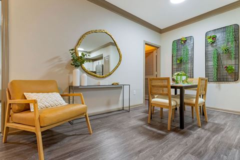 a living room with a table and chairs and a mirror at Summerwind, Pearland, TX 77584