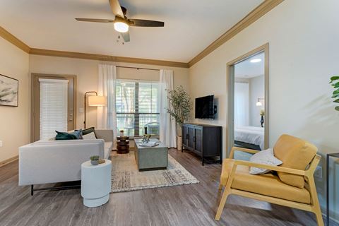 a living room with a ceiling fan and a couch at Summerwind, Pearland, TX