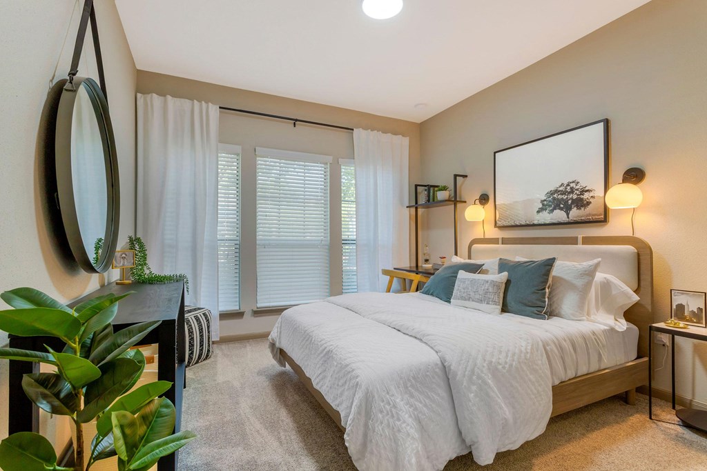 a bedroom with a large bed and a large window at Summerwind, Pearland Texas
