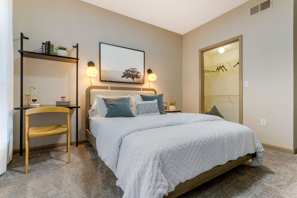 a bedroom with a large bed and a mirror