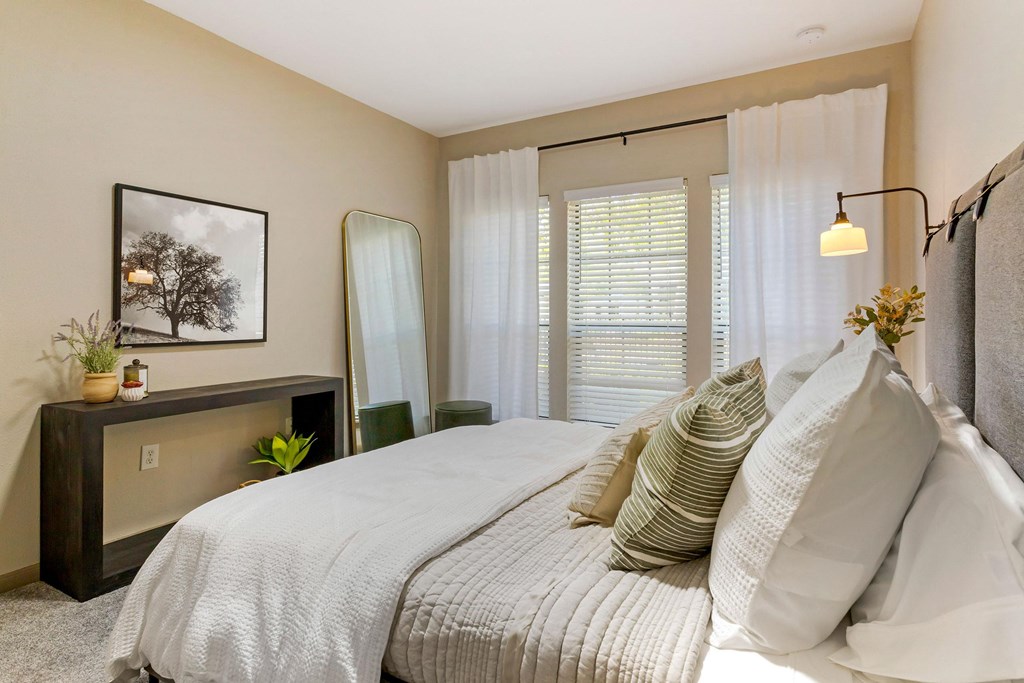 a bedroom with a large bed and a window at Summerwind, Pearland, 77584