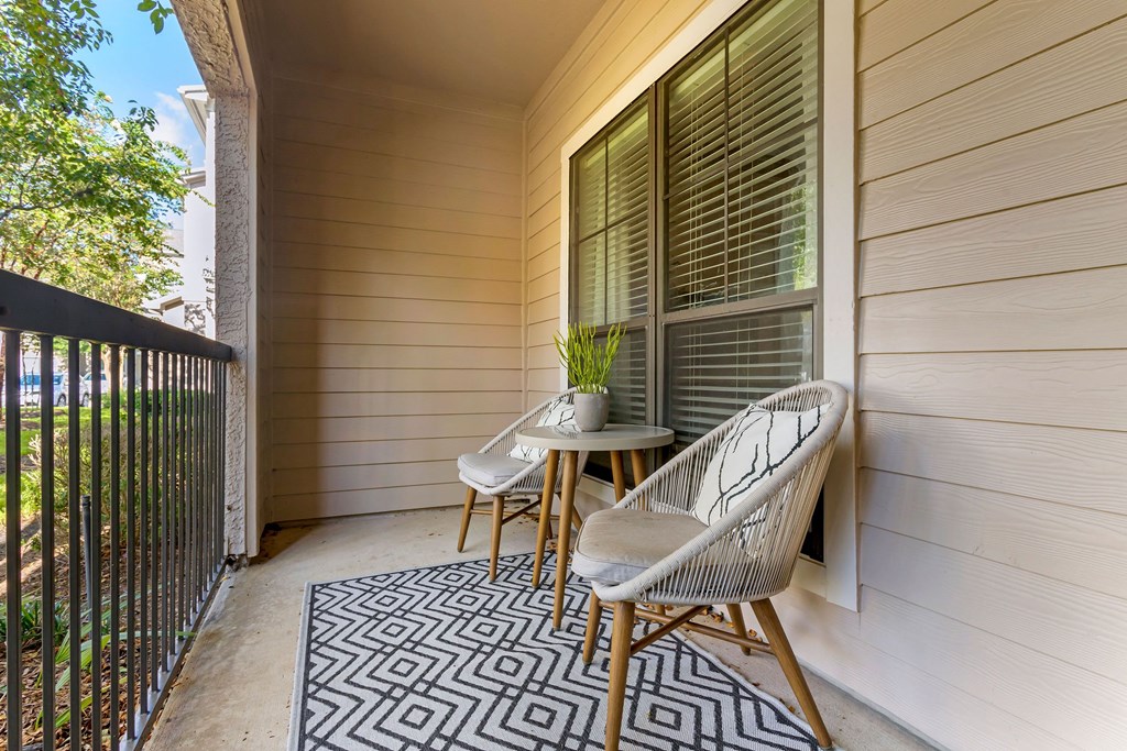 a balcony with a chair and a table on it at Summerwind, Texas