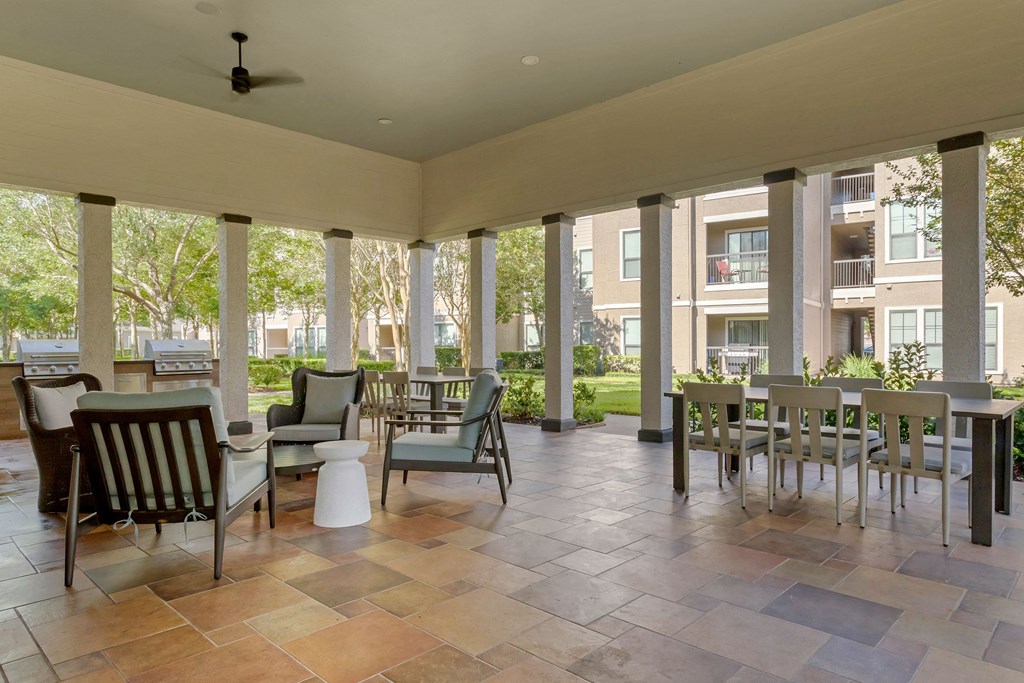 an outdoor patio with tables and chairs at Summerwind, Texas, 77584