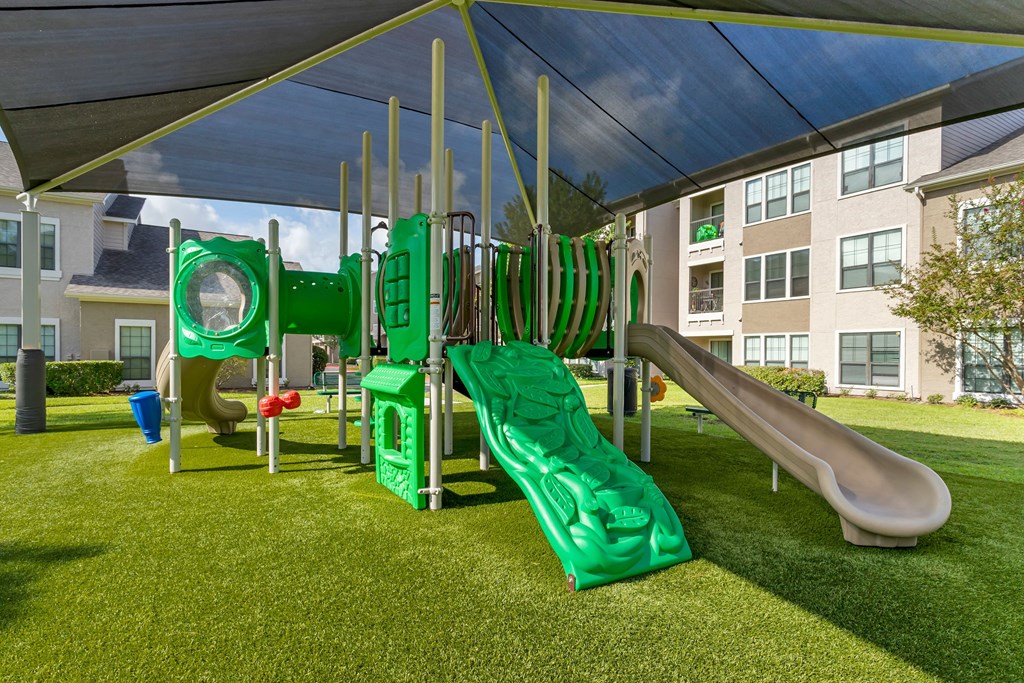 a playground with slides and a tent at Summerwind, Texas