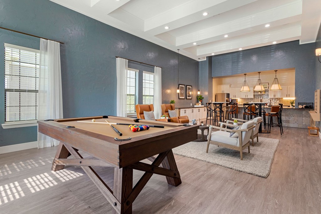 a pool table in a living room with a bar and a dining room at Summerwind, Pearland, 77584
