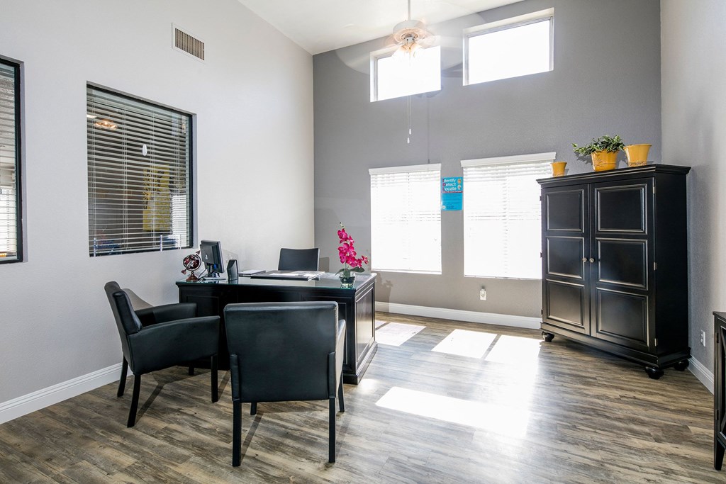 leasing office with a table and chairs and a large window at Sunset Winds Apartments, Henderson, NV 89014