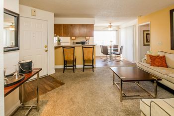 the view of a living room with a kitchen and a dining room at Sunset Winds Apartments, Henderson, NV