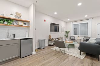 an open living room with a kitchen and a dining room at Apartments at Denver Place, Denver, CO