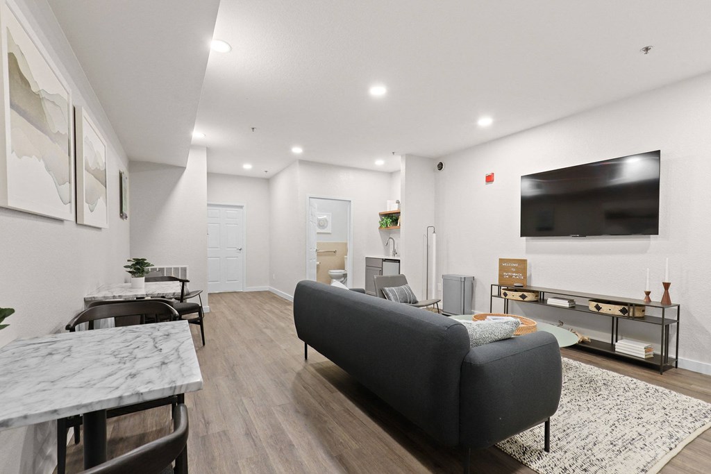 a living room with a couch and a tv  at Switchback on Platte Apartments, Littleton, Colorado