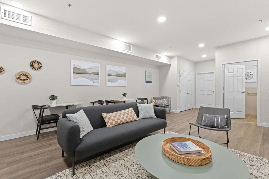 a living room with a couch and a table at Switchback on Platte Apartments, Littleton, CO