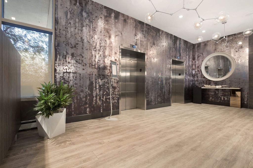 a large bathroom with a potted plant and a mirror at Apartments at Denver Place, Denver, CO 80202