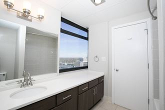 a bathroom with a sink and a window