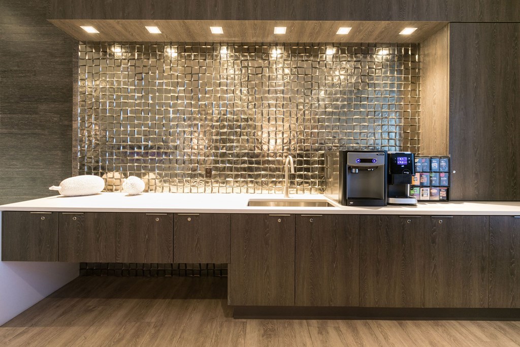 a kitchen with a counter and a coffee machine a kitchen with a counter and a coffee machine at Apartments at Denver Place, Denver