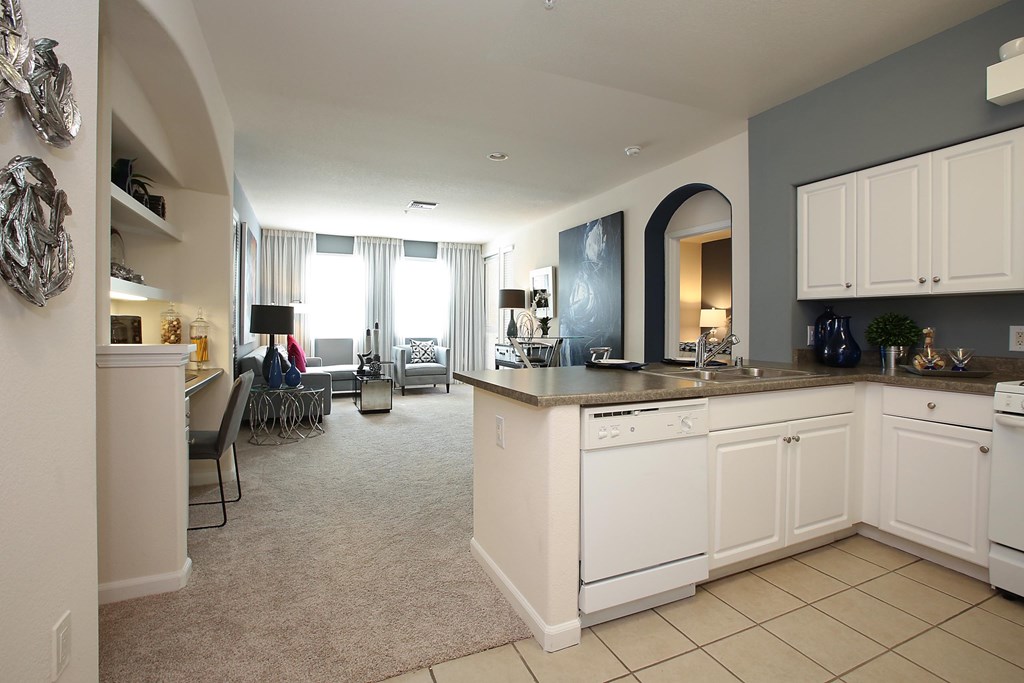 A kitchen with white appliances and cabinets at The Kitt at Warner Center Apartments, Woodland Hills