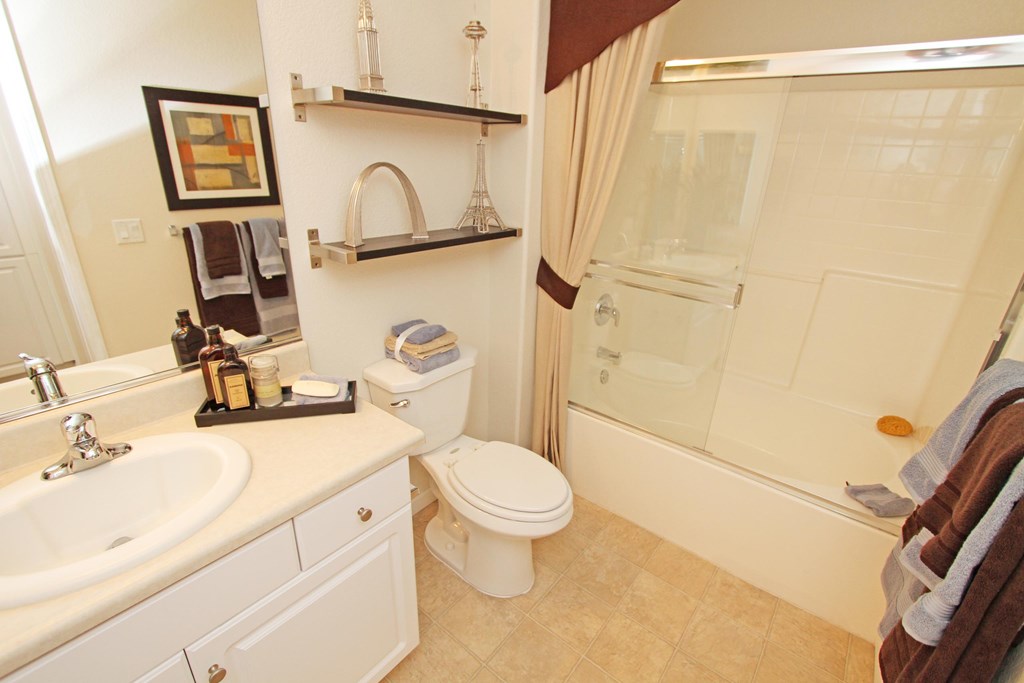 A bathroom with a toilet, sink, and shower at The Kitt at Warner Center Apartments, Woodland Hills, CA, 91303