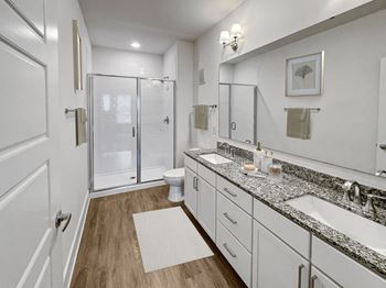 a white bathroom with two sinks and a shower at The Merchant Apartments, Charleston, South Carolina