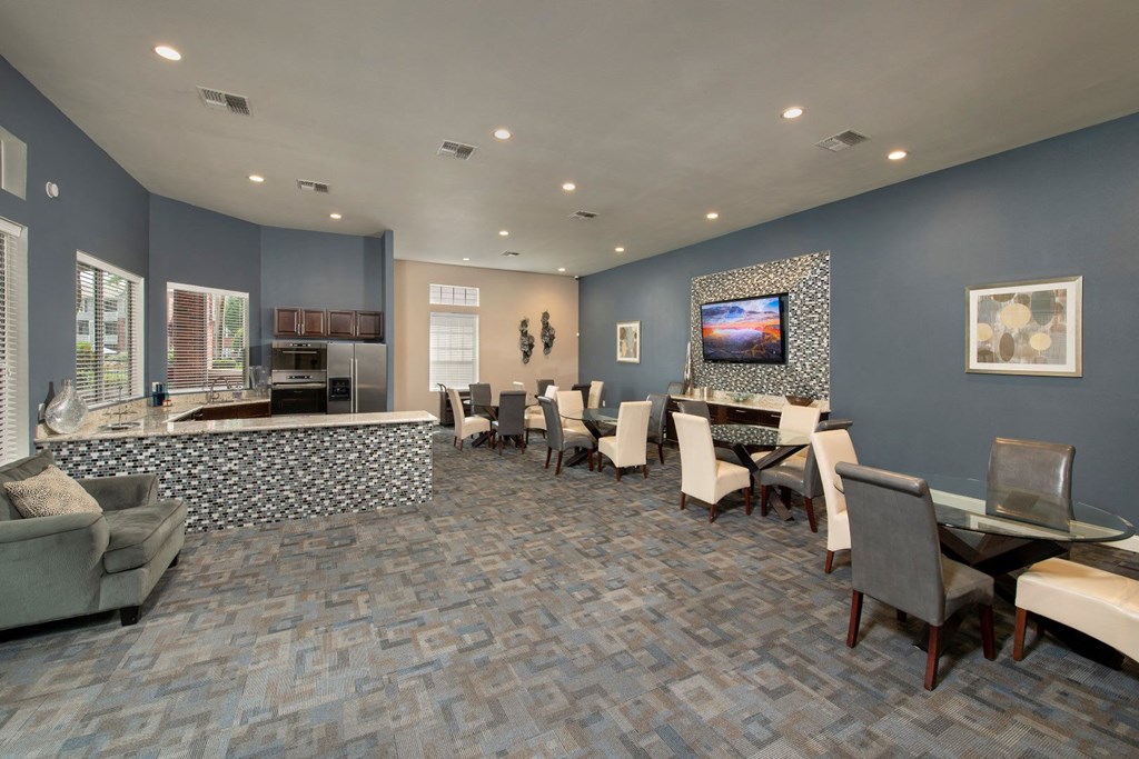 a conference room with a table and chairs and a television at Veranda at Centerfield, Texas