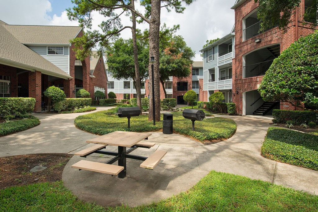 our apartments have a spacious courtyard with a picnic table and grills at Veranda at Centerfield, Houston, 77070
