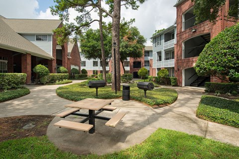 our apartments have a spacious courtyard with a picnic table and grills at Veranda at Centerfield, Houston, 77070
