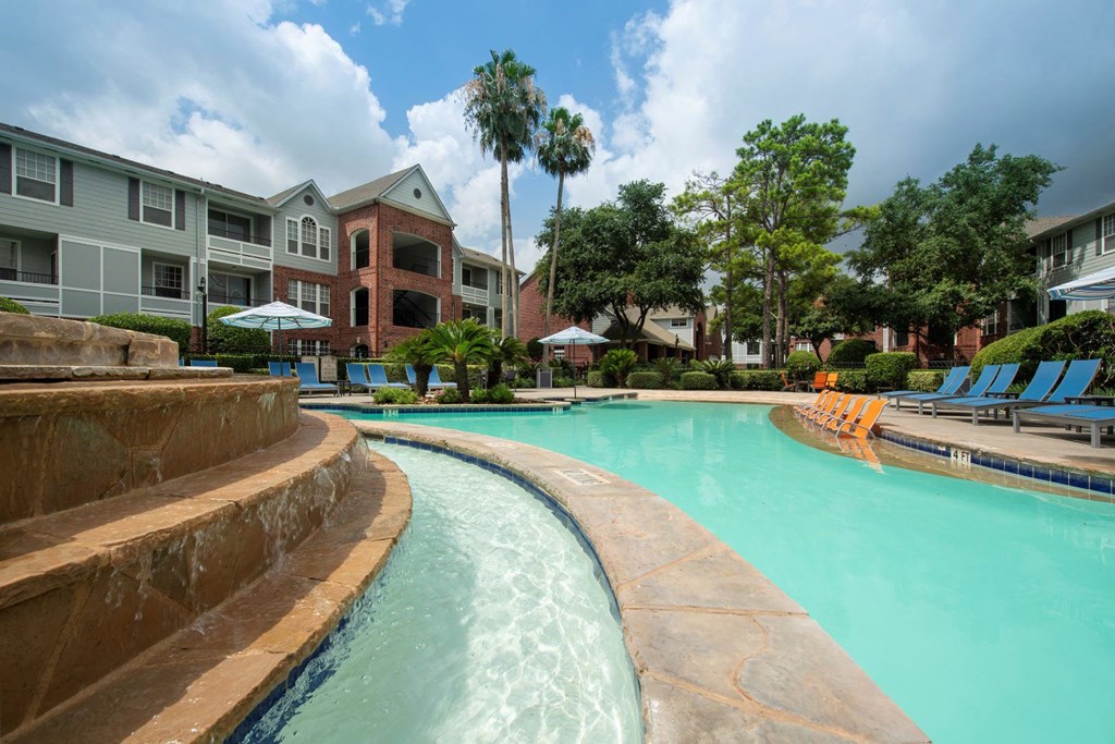 a large swimming pool with buildings in the background at Veranda at Centerfield, Houston