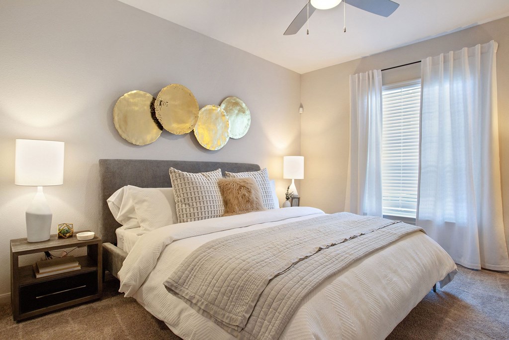 a bedroom with a bed and a ceiling fan