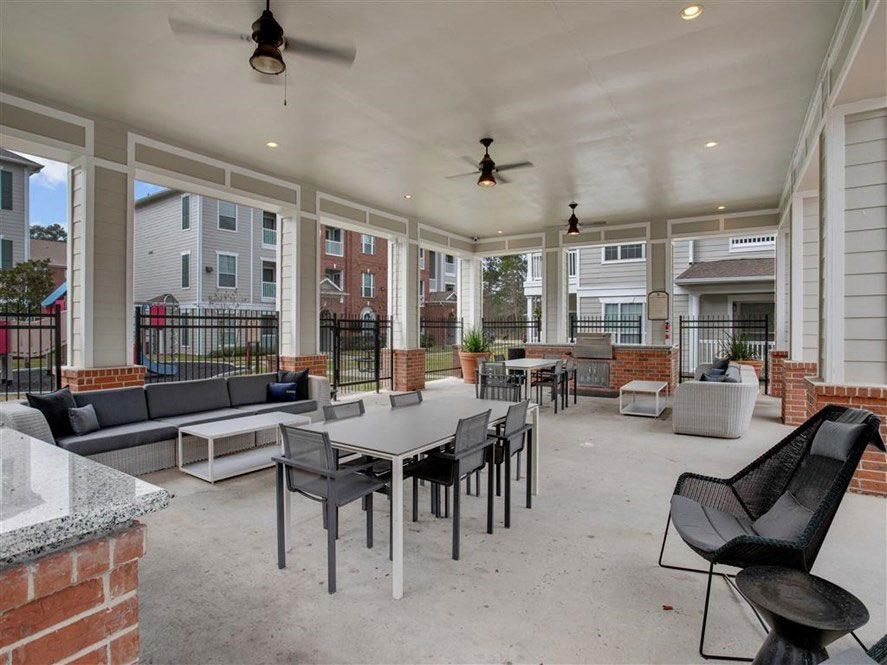 a large patio with tables and chairs