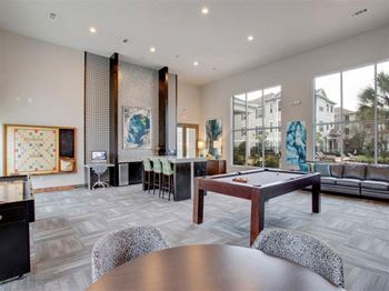 a large living room with a pool table