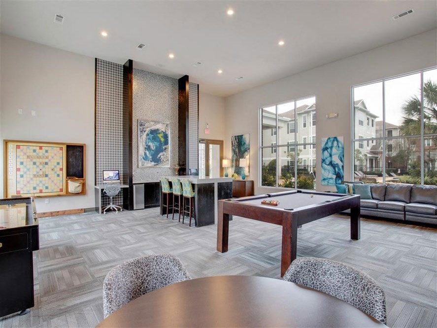 a large living room with a pool table
